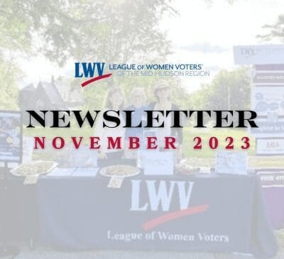 Three individuals stand behind a table with baked goods and information pamphlets, under a "League of Women Voters' of the Mid-Hudson Region" banner. The words "Newsletter November 2023" are overlaid on the image.