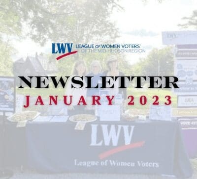 A display table with "League of Women Voters" and "Newsletter January 2023" text, with two people behind it and informational materials on the table.