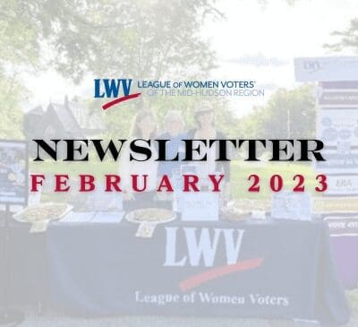 A newsletter cover for February 2023 from the League of Women Voters of the Mid-Hudson Region. It shows a few people standing behind a table with informational materials.